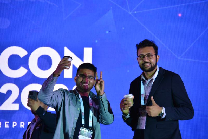 TiEcon volunteers, Vansh Gupta and Vaibhav Deshmukh share a coffee at the TiEcon 2023 Grand Keynote Stage.