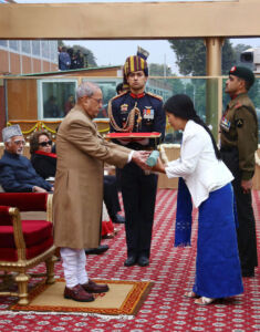 Chasen Lowang Dada, the widow of martyr Hav Hangpan Dada receiving Ashoka Chakra from President Pranab Mukherjee on behalf of her husband on the occasion of the 68th Republic Day Parade at Rajpath in New Delhi, Jan. 26. (Press Trust of India) page-2017-india-republic-day-32