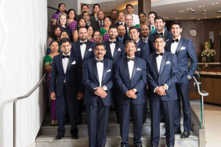 The Bhindi family and staff pose for a picture. page-bhindi-04-team