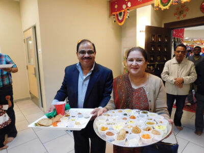 Devoted couple participating in the “Chhappan Bhog.” page-chhapanbhog-11