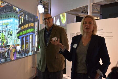 Dag Spicer (l) looks on Kirsten Tashev talks about the large wall poster in Photoshop gallery, famed artist Bert Monroy artwork Times Square is 22 feet long and 4 feet high and was created over four years. It contains over 750,000 layers in Photoshop and depicts Times Square with dozens of digital imaging artists and pioneers, including Photoshop creators John and Thomas Knoll, as well as some of Monroy’s family and friends. page-computer-10