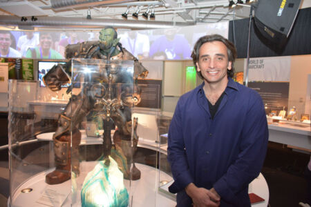Gio Hunt, EVP of Corporate Operations at Blizzard Entertainment, the company that owns World of Warcraft poses next to the WoW exhibit. (Amar D. Gupta/Siliconeer) page-computer-40