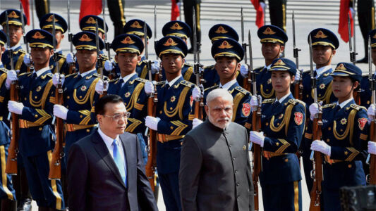Prime Minister Narendra Modi with Chinese Premier Li Keqiang inspecting the guard of honor during a ceremonial welcome outside the Great Hall of People in Beijing, China, May 15. (Shahbaz Khan | PTI) page-may21-modi-03-china