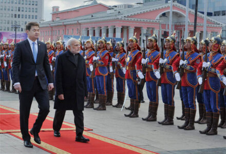 Prime Minster Narendra Modi walks with his Mongolian counterpart Chimed Saikhanbileg as they inspect a guard of honor during the ceremonial welcome at State Palace in Ulan Bator, Mongolia, May 17. (Shahbaz Khan | PTI) page-may21-modi-17-mongolia