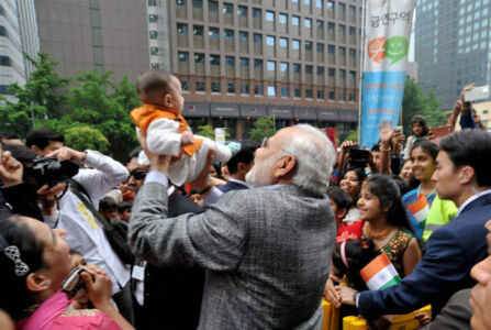 Prime Minister Narendra Modi plays with a child during a visit to the Cheonggyecheon Stream in Seoul, South Korea, May 19. (PTI | MEA) page-may21-modi-24-korea