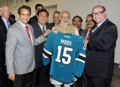 Prime Minister Narendra Modi is presented a San Jose Sharks jersey at SAP Center in San Jose, Calif., Sept. 27. Also seen are Chandru Bhambra, Naren Gupta, Khanderao Khand and other officials and organizers. (Press Trust of India) page-modi-03-pti