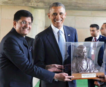 U.S. President Barack Obama being presented a bust of Mahatma Gandhi during his visit to Rajghat in New Delhi, Jan. 25. (Press Trust of India) page-modi-obama-15
