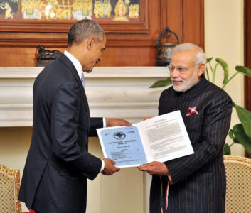 Prime Minister Narendra Modi presenting a reproduction of a telegram sent by USA to the Indian Constituent Assembly in 1946 to President Barack Obama, in New Delhi, Jan. 25. (Press Trust of India) page-modi-obama-16
