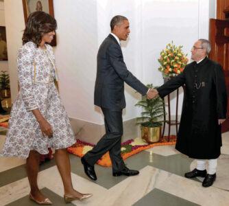 U.S. President Barack Obama shakes hand with Indian President Pranab Mukherjee as First Lady Michelle Obama looks ahead of an At Home reception on the occasion of 66th Republic Day at the Rashtrapati Bhavan in New Delhi, Jan. 26. (Press Trust of India) page-modi-obama-33