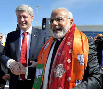 Indian Prime Minister Narendra Modi shakes hands with and his Canadian counterpart Stephen Harper on their arrival at Lester B. Pearson International Airport in Toronto, Canada, Apr. 15. (Press Trust of India) page-modi-toronto-05-inside