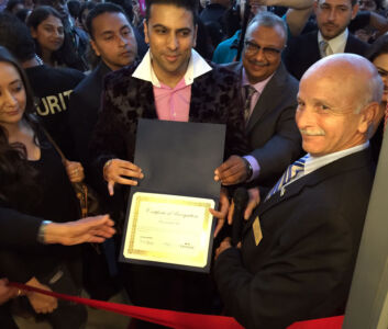 PNG Group Chairman & MD Saurabh Gadgil holds a certificate on the ribbon cutting of the Fremont store. (Photo: PNG Jewelers) page-png-gallery-one-05