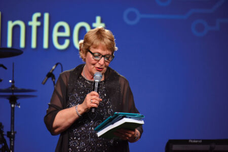 Brenda H. Christensen, author of “The $8 Man,” reads a piece from her book at the TiE Banquet. (Vansh A. Gupta) page-tiecon-2017-banquet-07