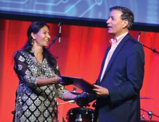 Jay Chaudhry, CEO and founder of Zscaler receives Entrepreneur of the Year award from his wife. page-tie-16-dsc_7876