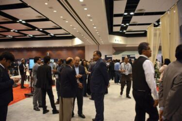 TiE past president Venk Shukla (c) in conversation with attendees at the TiE Inflect 2018 expo. page-tie-45-dsc_7387