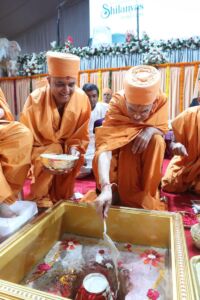 Mahant Swami Maharaj pours cement into the foundation during the Vedic rituals of the Shilanyas Ceremony of the first Hindu Mandir in UAE page-uae-baps-hindu-temple-02