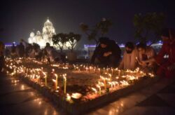 Indian Sikh devotees light candles at sunset during the Diwali Festival at the illuminated Gurdwara Bangla Sahib Temple in New Delhi, Nov. 4, 2021. (Siliconeer/APHIMAGES)