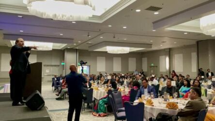 Jag Kapoor of Bonfare Markets chain of superstores raising bids for the 'Khushii' fundraiser in Palo Alto, Calif., July 27.